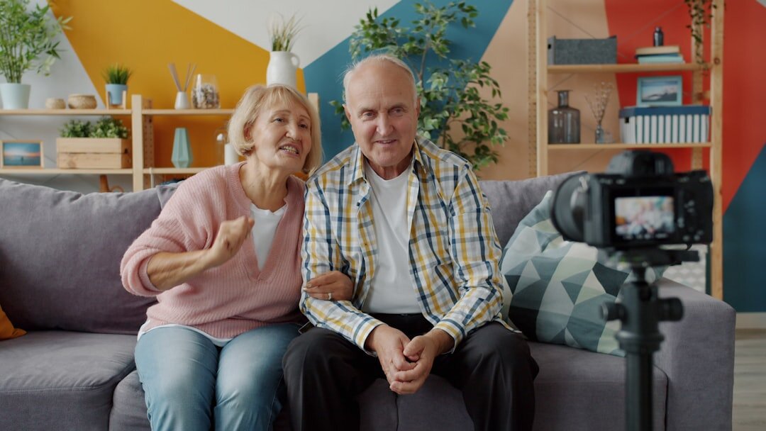 Photographer interviewing an elderly Danish man in his living room