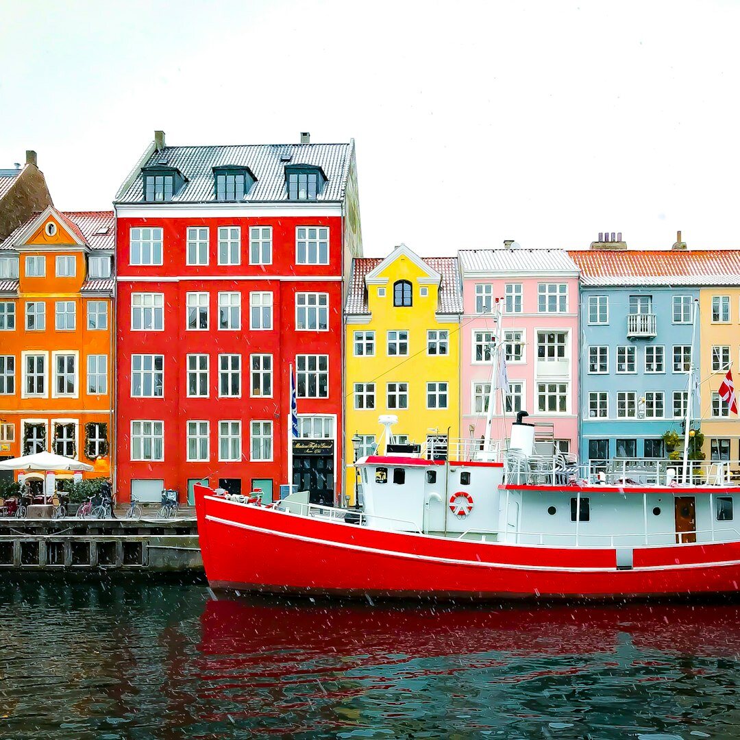 A small fishing village in Denmark with colourful houses and boats