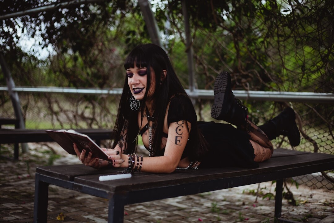 young woman reading on bench